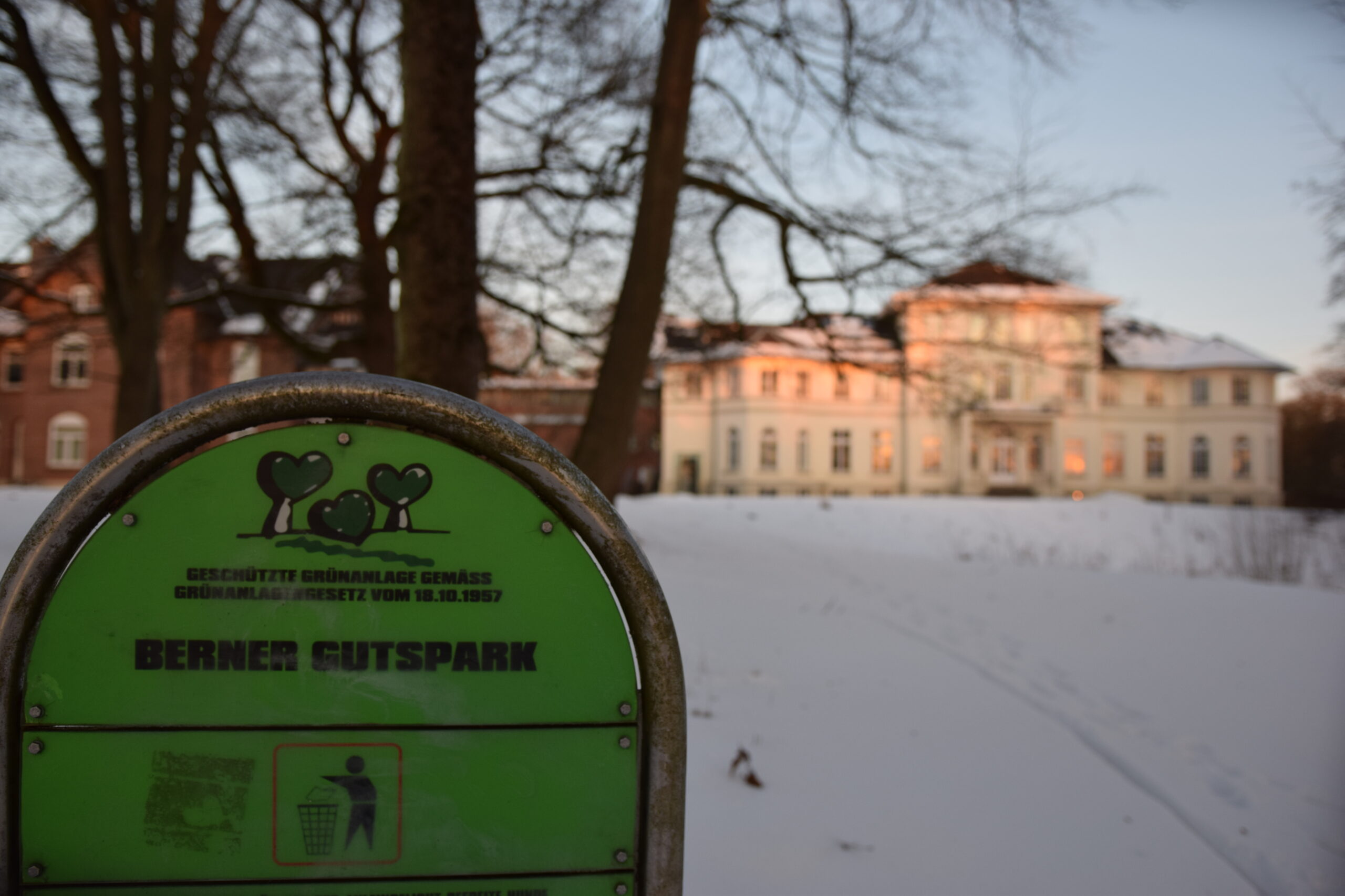 Der Berner Gutspark im Schnee, im Hintergrund das Berner Schloss im Sonnenuntergang